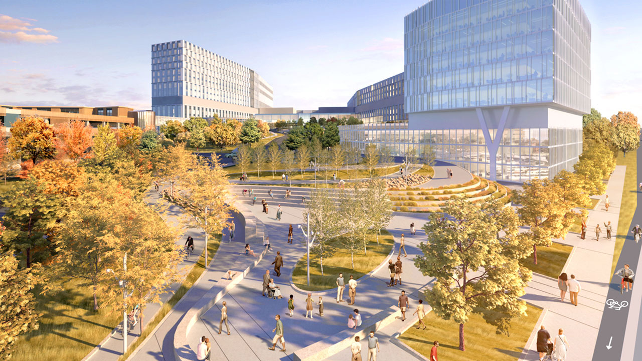 An artist rendering of The Ottawa Hospital’s new campus from Carling Avenue in Ottawa. On the left is an escarpment of mature trees that leads to the main entrance of the hospital. The main building is in the background. Bicycle and walking paths wind through the natural landscapes of trees and grass from the main street to the main entrance and across the campus.  There are people on bicycles and walking in the outdoor space on a sunny day.  