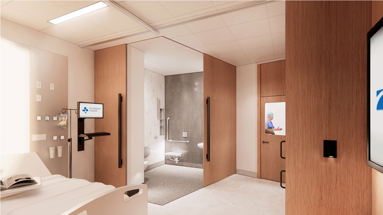 An artist rendering of a patient room at the new hospital. In the corner of the room close to the bed, there is a sliding door that is open, revealing a fully accessible bathroom. There is also a window in the door to the hallway that shows a physician walking down the hall.