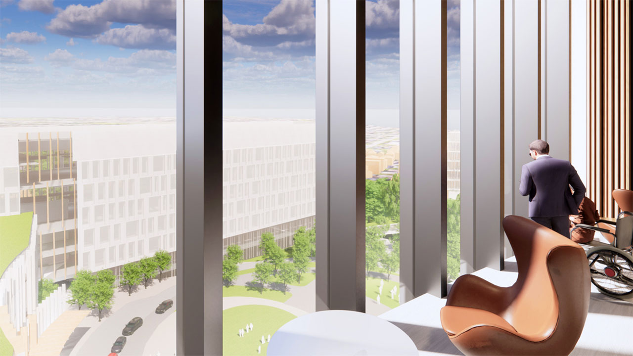 An artist rendering of a patient and family lounge on one of the highest floors of the new hospital. One person is standing, and another is in a wheelchair, both are looking through the floor to ceiling windows and down to the main hospital entrance. Grass and trees are part of the natural landscape in front of the entrance.