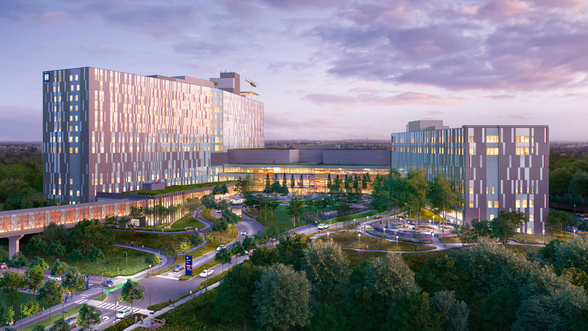 An artist rendering of The Ottawa Hospital’s new campus at dusk, showing the front exterior of the entire hospital. Trees, entry roads and vehicles are in the foreground in front of the hospital. A covered pedestrian bridge extends from the front of the building to the left and out of frame.